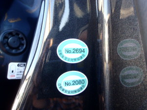Stickers indicating Japanese import car recalls have been done